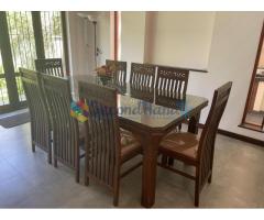 Wooden dining table with glass top (8-seater)